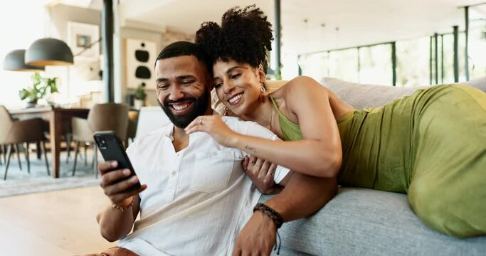 Couple, new home and phone for entertainment, bonding and love in lounge on weekend for relaxing. Man, woman and ethnic people by living room, sofa and couch while looking at social media online