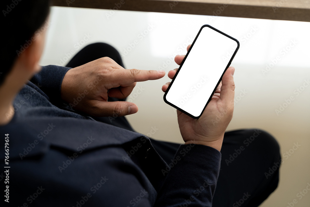 Poster top view mockup image hand using a smartphone man holding cell phone with blank screen