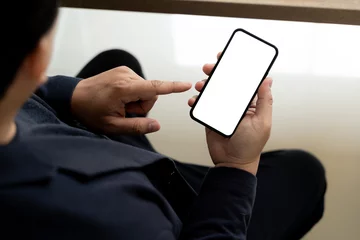 Poster Top view Mockup image hand using a smartphone man Holding Cell Phone With Blank Screen © onephoto