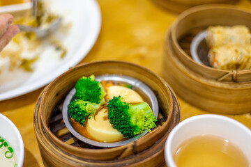 The background of food that is put in a wooden container (dim sum) containing vegetables, pork, flour Used to make, a menu that requires steaming stoves for good taste, delicious to eat