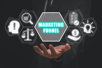 Marketing funnel concept, Businessman hand holding marketing funnel icon on virtual screen.