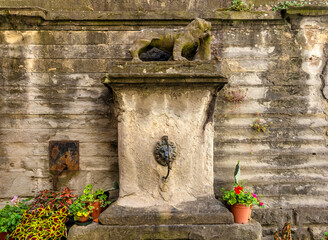 Ancient Roman fountain with an eroded column in Rome, Italy