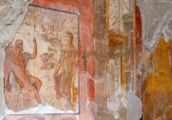 Ancient Roman frescos on a wall in Pompeii, Italy