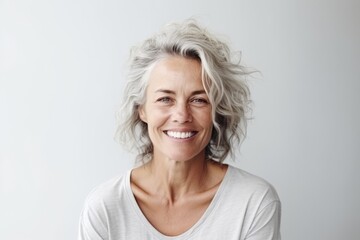 Portrait of a beautiful senior woman smiling at the camera with a white background - obrazy, fototapety, plakaty