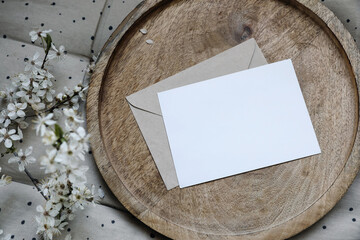 Spring still life composition. Blank greeting card mockup, craft envelope. Feminine styled photo....