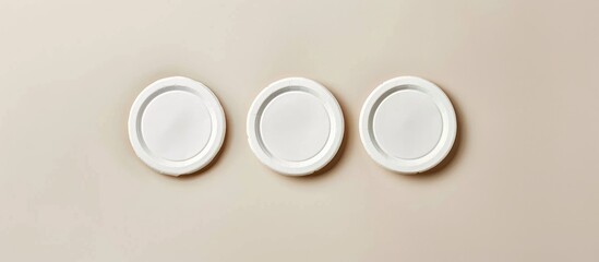 Three empty white beer coasters on a paper backdrop. Mockup featuring responsive design layout. Top-down view.