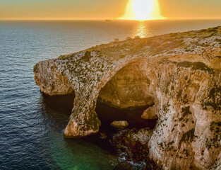 Beautiful sunset at Blue Grotto , complex of seven caves found along the southern coast of Malta. 