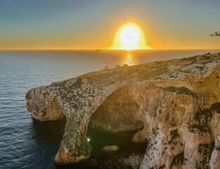 Beautiful sunset at Blue Grotto , complex of seven caves found along the southern coast of Malta. 