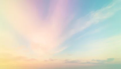 Fotobehang bright pastel rainbow gradations of green pink blue purple and gently orange a subtle blend on the atmospheric background of the beautiful natural sky with softly faded white clouds © Leila