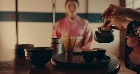 Culture, teapot and Japanese women pouring tea with traditional leaves and indigenous in home. Health, ceremony and people with herbal beverage for relaxing, wellness and detox for drinking ritual