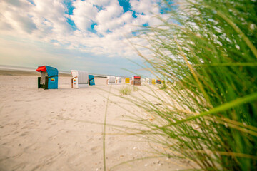 White sandy beaches and sandy grass of the North Sea in Germany.Beach Green grass and Beach cabins...
