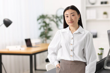 Portrait of beautiful businesswoman in office. Space for text