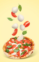 Caprese pizza and ingredients in air on pale yellow background