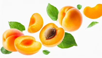Poster Apricot with half slices apricots falling or flying in the air with green leaves isolated on white background. Generative AI. © Hulinska Yevheniia