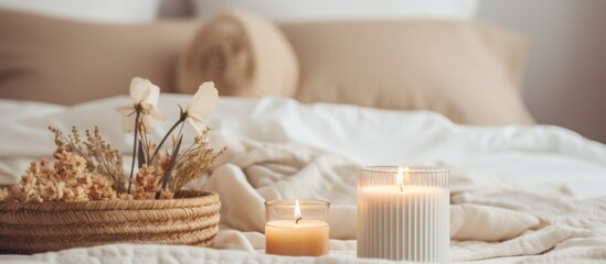 Fototapeta na wymiar In the room, there are two candles placed on a hardwood nightstand and a wicker basket filled with dried flowers. The home accessories add a touch of rustic charm to the cozy ambiance