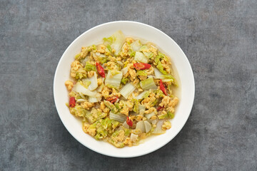 Tumis Sawi Telur or stir fry egg cabbage, Indonesian food
