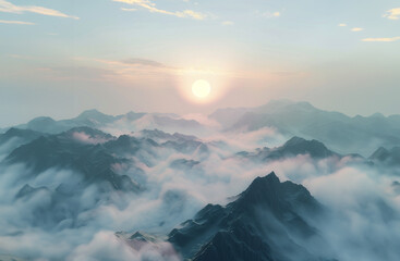 View from on top of a mountain of the fog, mist and clouds surrounding a mountain range at sunrise..