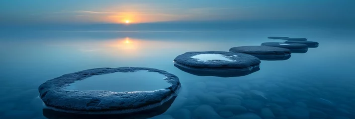 Tafelkleed a group of rocks sitting in the middle of a lake under a cloudy sky © progressman