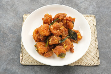 Salted egg fried shrimp or udang telur asin with curry leaves
