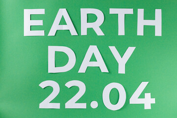 Earth Day Inscription with White Paper Letters on Green Background