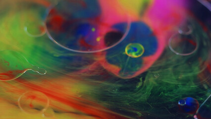 Oil bubbles. Paint water mix. Color mist. Blur vibrant pink blue green orange transparent texture ink gel blob floating abstract art background.