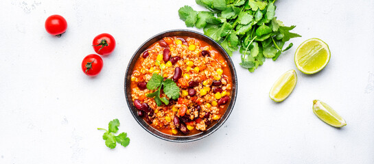 Chili con carne, mexican dish with minced beef, red beans, paprika, corn and hot peppers in spicy...