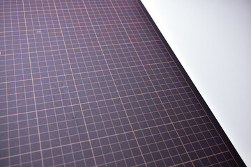 black cutting mat board on white background with line and scale measure guide pattern for object...