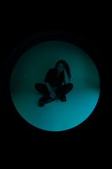 A woman sitting in the dark