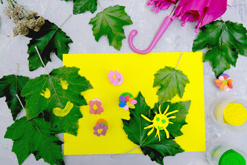Child playing with plasticine and  paper and natural leaves. Protection of environment, Save our...
