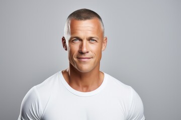 Portrait of handsome mature man in white t-shirt over grey background. - obrazy, fototapety, plakaty