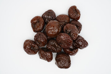 Heap of dried plums isolated background