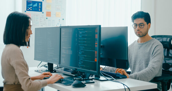 Group Adult Asia male, female freelance typing write prompt AI bot IT app smart program nomad, video game, terminal with coding language, user interface, designer, big data center on desktop computer.