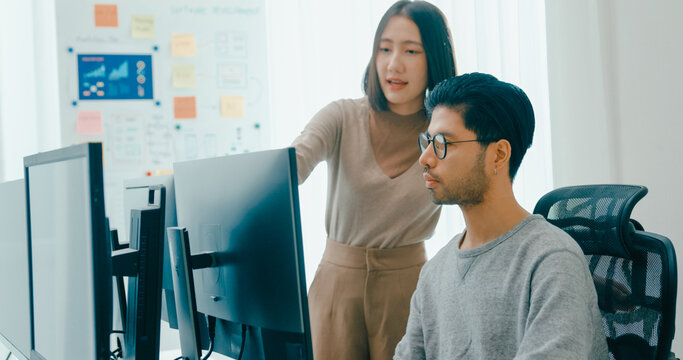 Group Adult Asia male, female freelance meeting write prompt AI bot IT app smart program nomad, video game, talk strategy, discuss plan, user interface, designer, big data center on desktop computer.