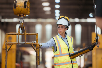 Portrait of railway technician worker in safety vest and helmet working at train repair station