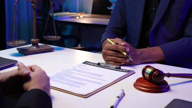 Lawyer reads statute of limitations Verify correctness in contract documents Consultation between a male lawyer and a business client, a tax company, in business before signing a contract.