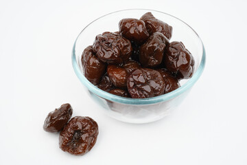 Many prunes in a glass bowl Isolated Background