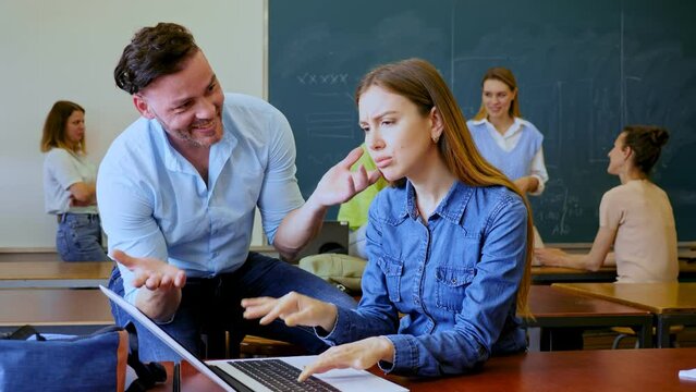 Man trying to flirt with woman during recess in university. Students meet in classroom.