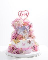 pink wedding cake with decoration with pink flower and cream on white,Food and flower wedding concept. - 766751899