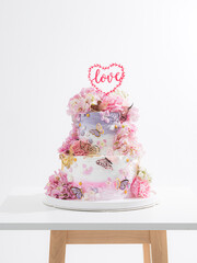 pink wedding cake with decoration with pink flower and cream on white,Food and flower wedding concept. - 766752012