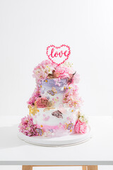 pink wedding cake with decoration with pink flower and cream on white,Food and flower wedding concept. - 766752025