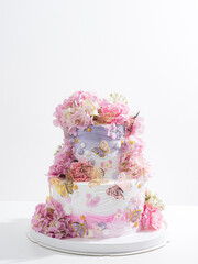 pink wedding cake with decoration with pink flower and cream on white,Food and flower wedding concept.