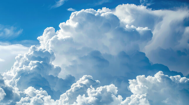 Large white clouds against a blue sky background