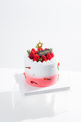 Delicious birthday cake with fresh strawberries, on wooden table and white background. Free space for your text.