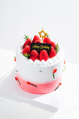 Delicious birthday cake with fresh strawberries, on wooden table and white background. Free space for your text.