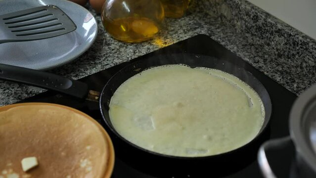 Appetizing sweet pancakes  in pan  in kitchen