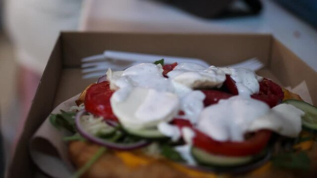 Woman taking photo of delicious fresh traditional hungary langos