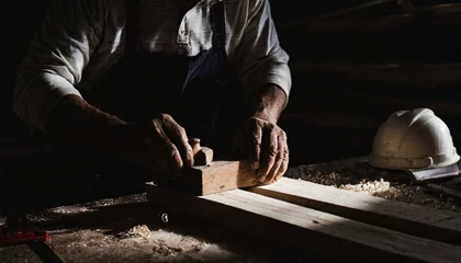 Cercles muraux Ancien avion Carpenter's hands planing a plank of wood with a hand plane, in factory, old, dark 