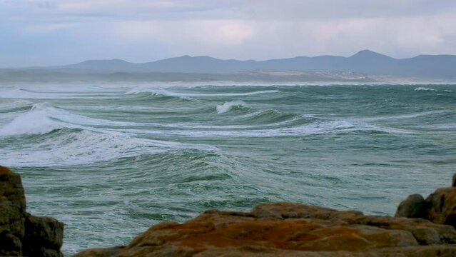 Time lapse of waves rolling in toward coastline, Walker Bay, Hermanus. Telephoto