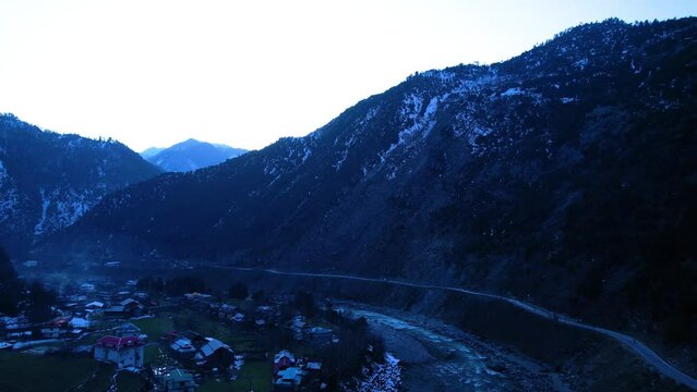 Aerial view of Neelum Valley River Old Kishan Ganga River with the background Himalayan mountains and Salkhala village visible clearly with residential houses