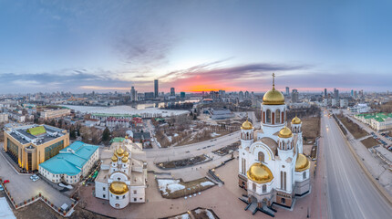 Spring Yekaterinburg, Temple on Blood and Church of St Nicholas in sunset. Aerial view of Yekaterinburg, Russia. Translation of text on the temple: Honest to the Lord is the death of His saints - obrazy, fototapety, plakaty